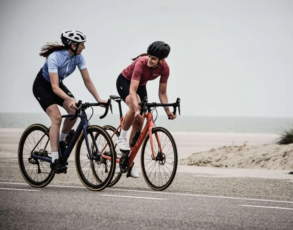 Two cyclists on a seaside road