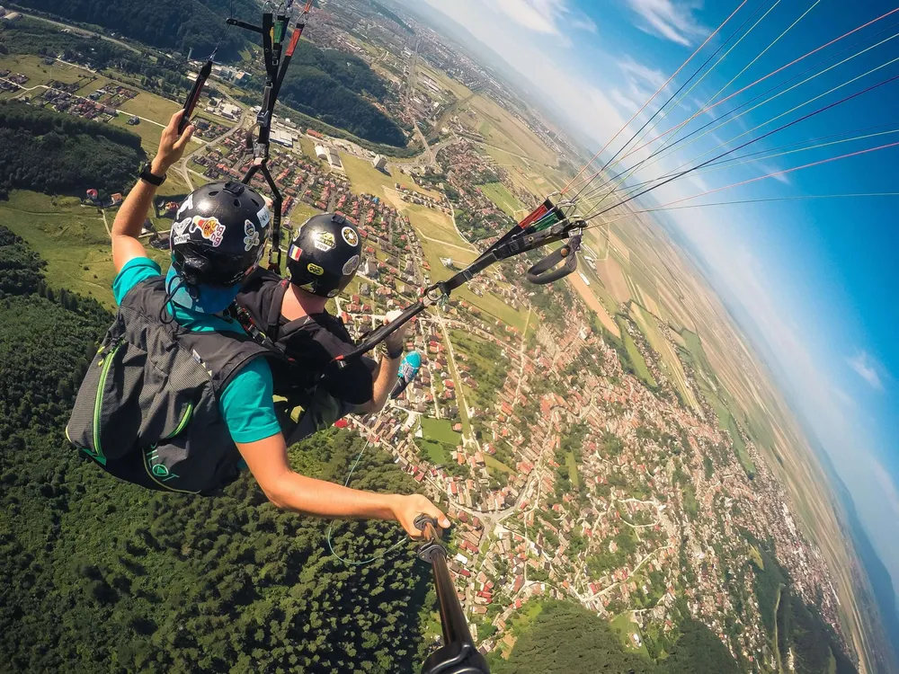 Tandem paragliding flight over the countryside